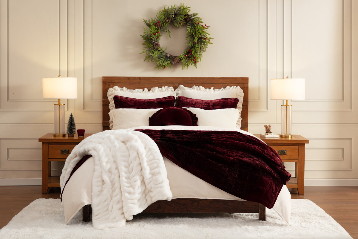 A bed layered in holiday bedding